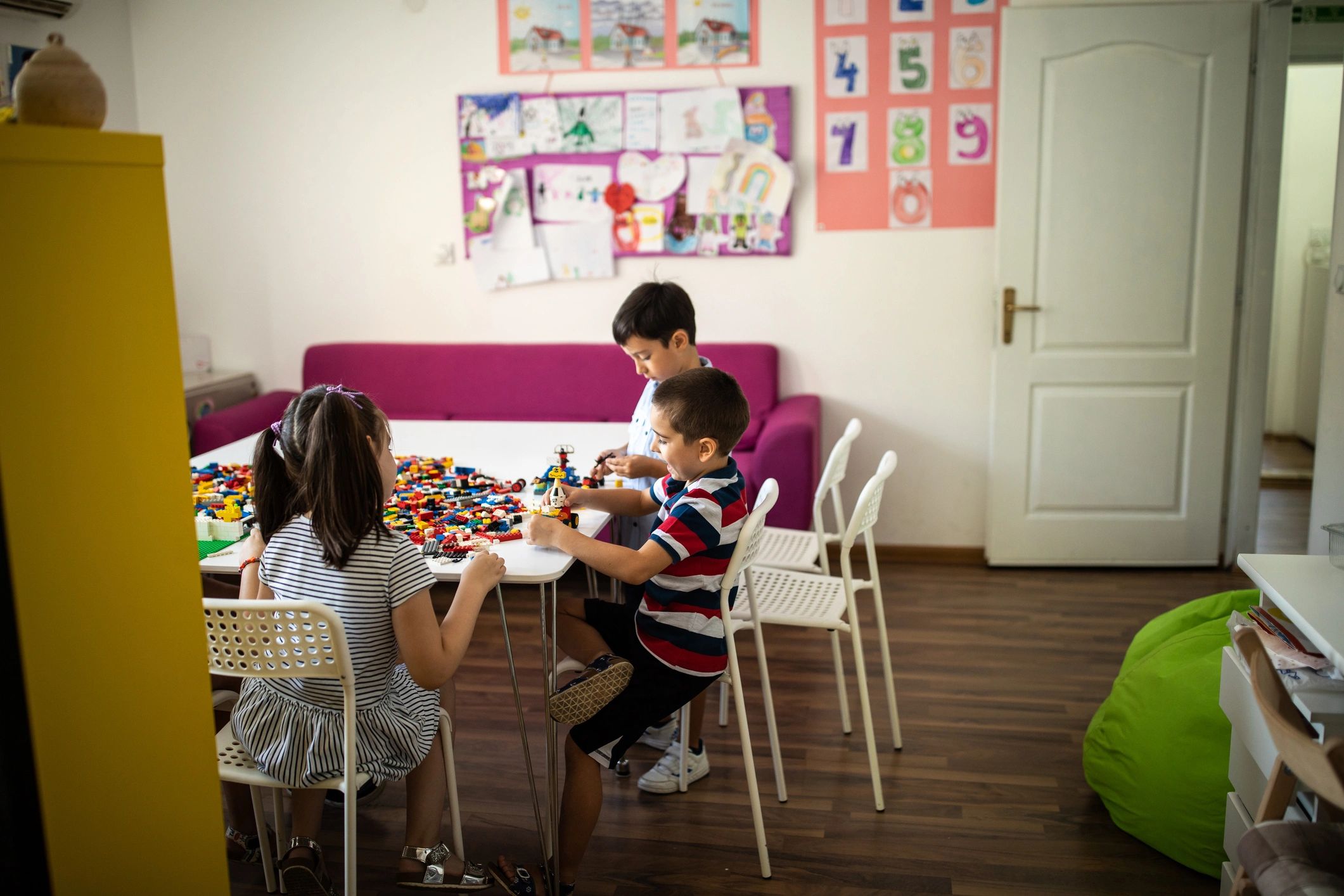 Kids enjoying playtime with toy blocks at daycare classroom