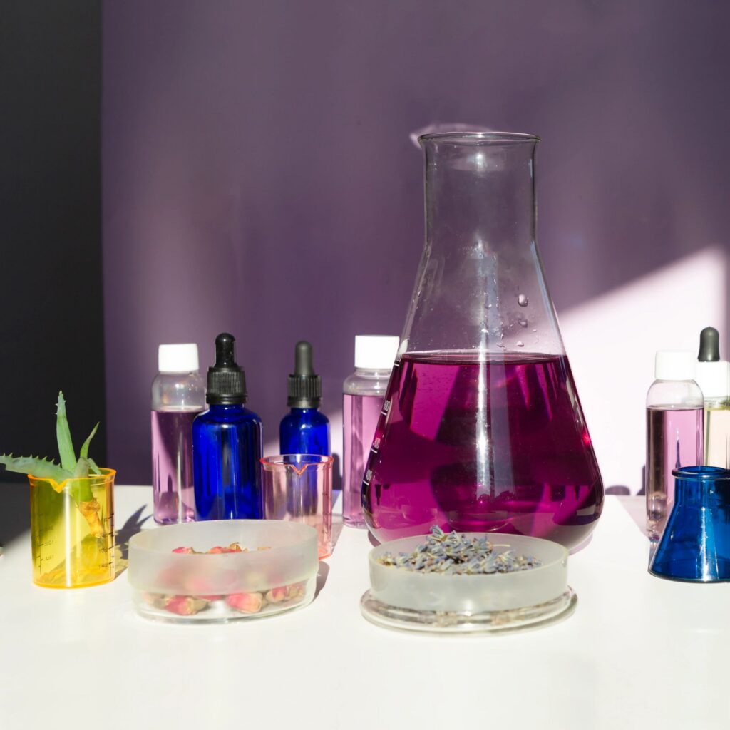 Abstract cosmetic or chemical laboratory. Laboratory equipment, flasks, test tubes, petri dishes. Creative concept with hard shadows.