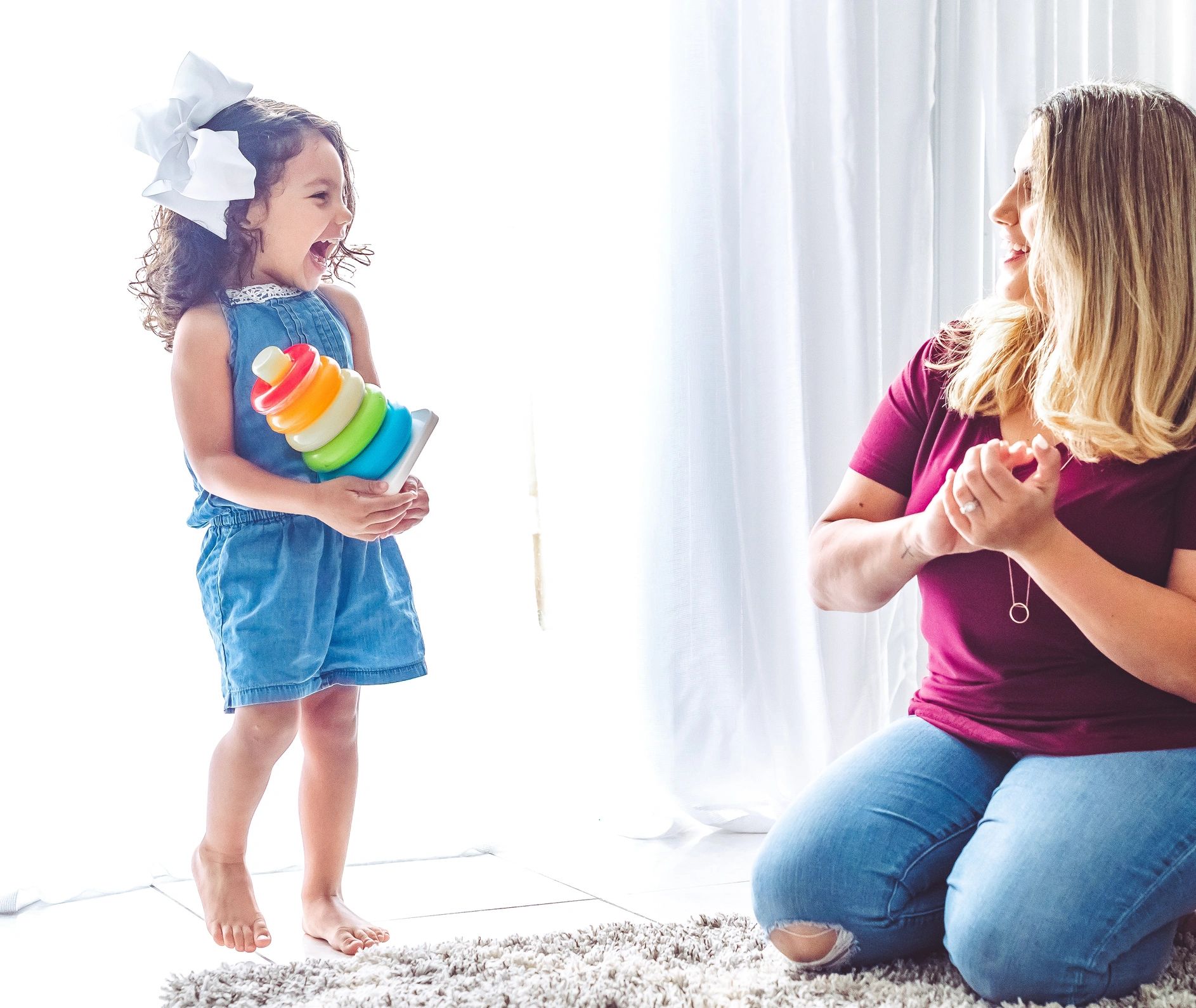 Parent and child playing with a toy together