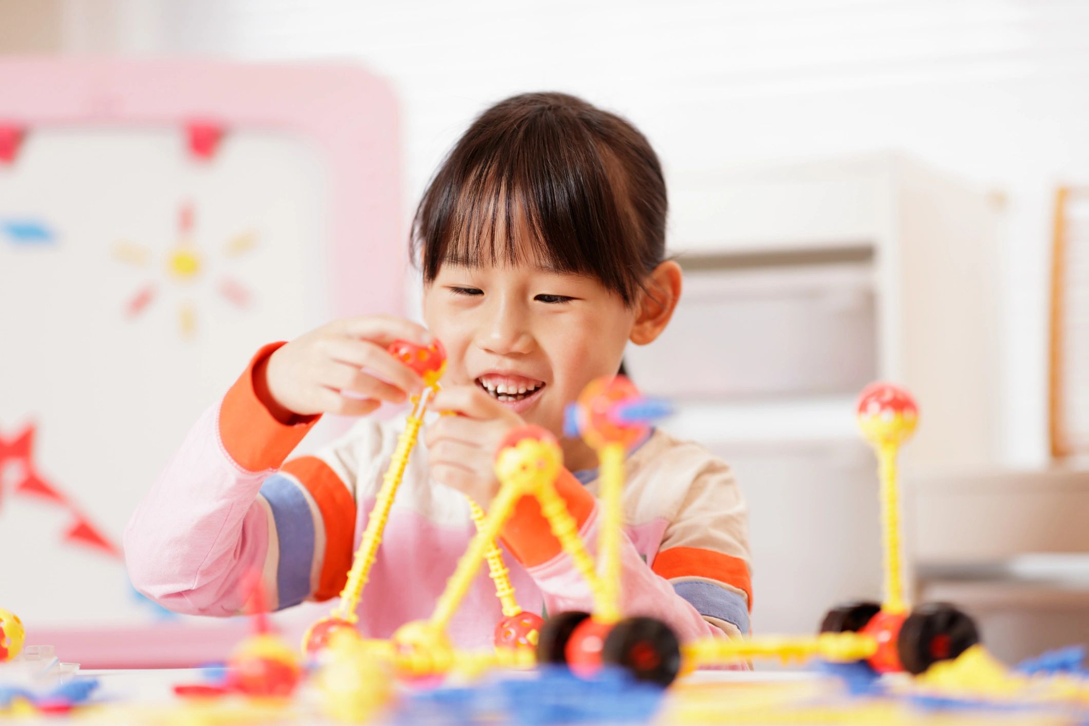 Child playing with construction toys at home
