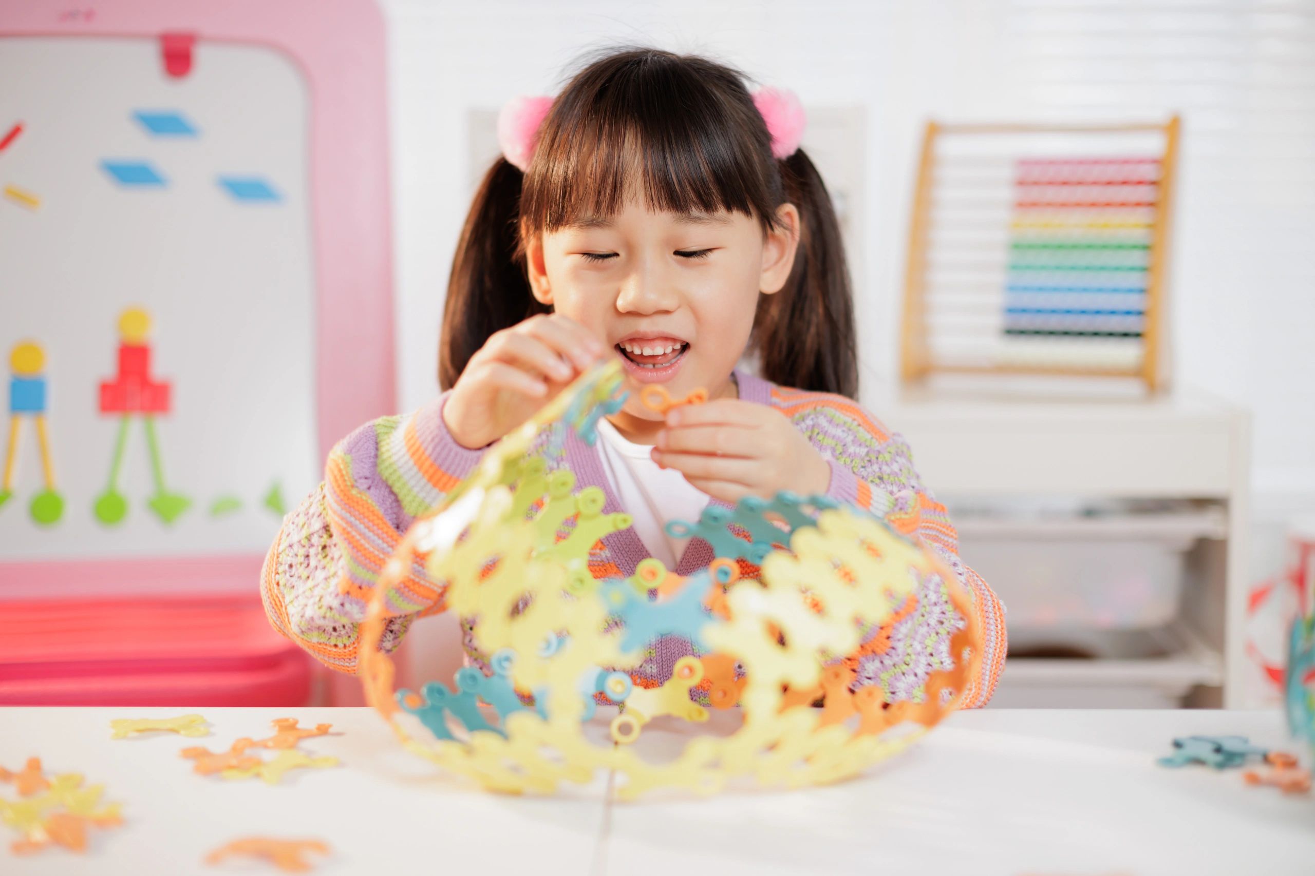 Young girl playing with construction toys at home