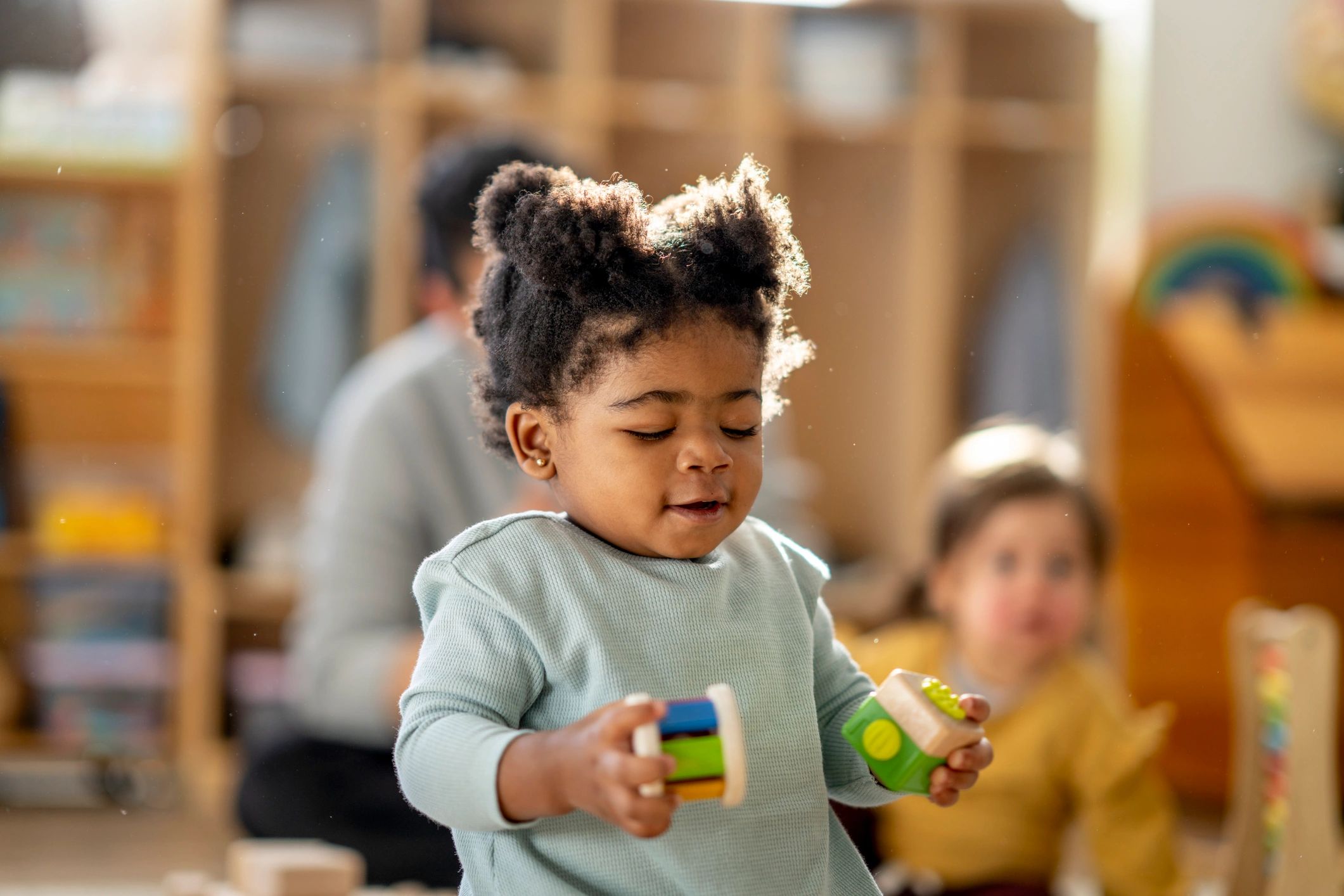 Young child playing with colourful building blocks