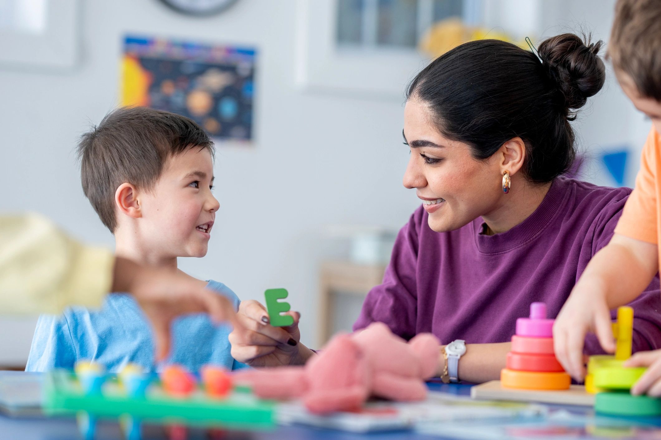 Teacher supporting a child during creative educational play