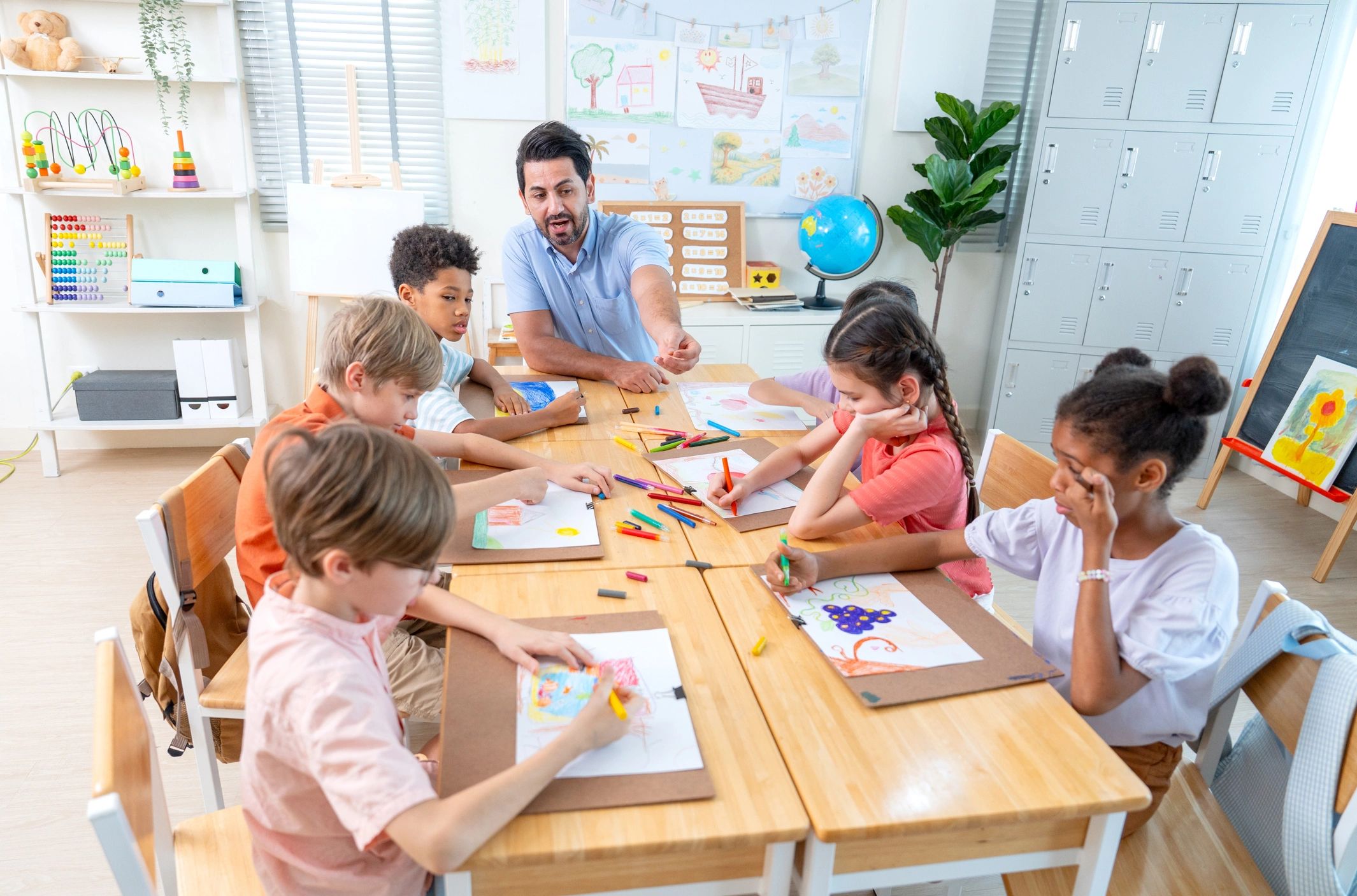 Teacher guiding children in a creative classroom setting