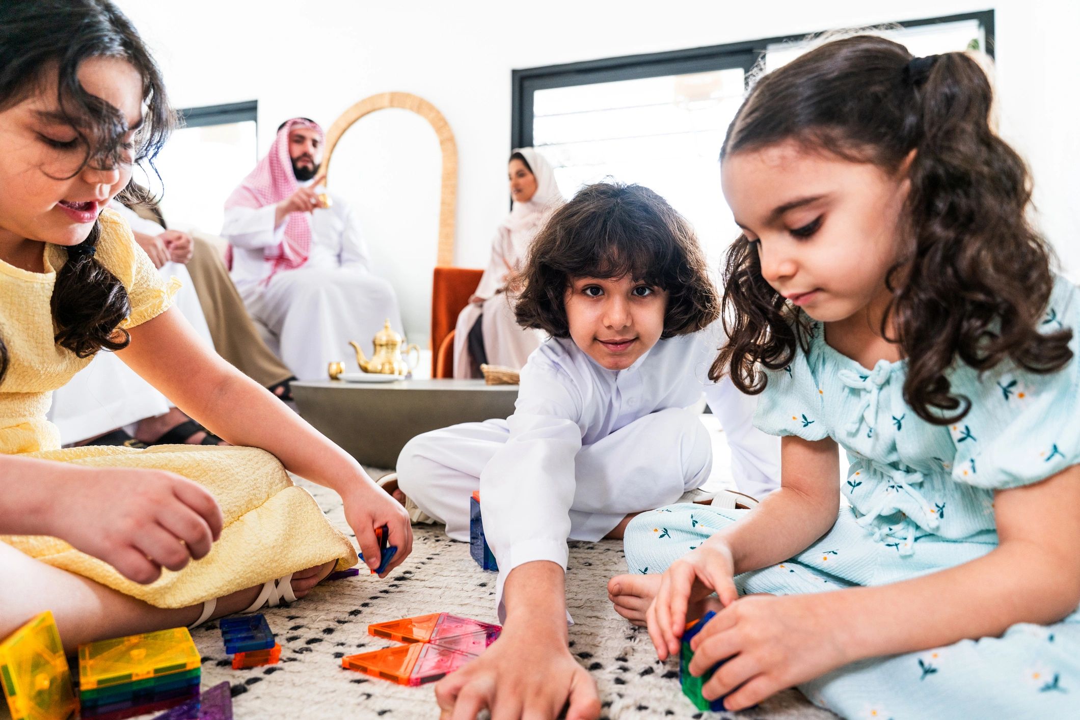 Children playing with magnetic building toys at home